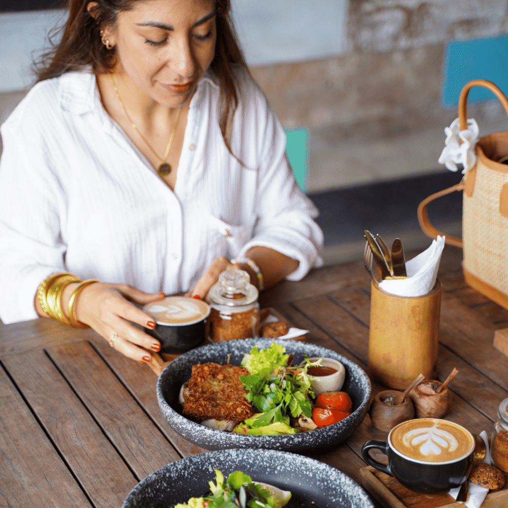 Bali’s Best 7-Day Retreat: Yoga, Wellness & the Art of Slowing Down 8 Woman having a healthy breakfast and coffee at a Genius café