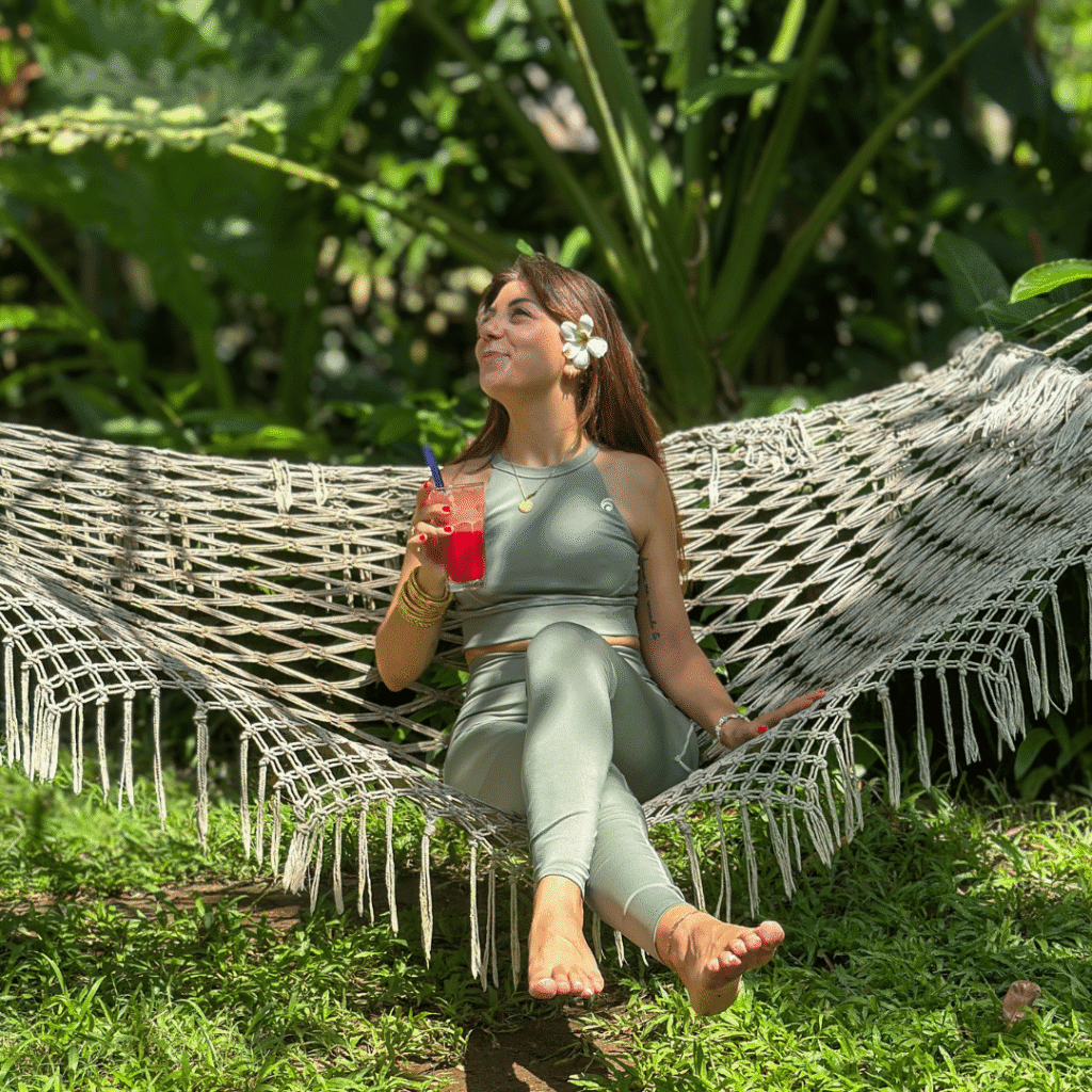Bali’s Best 7-Day Retreat: Yoga, Wellness & the Art of Slowing Down 2 Bali 7-Day Retreat – woman relaxing on a hammock with a fresh drink, surrounded by tropical greenery in Bali